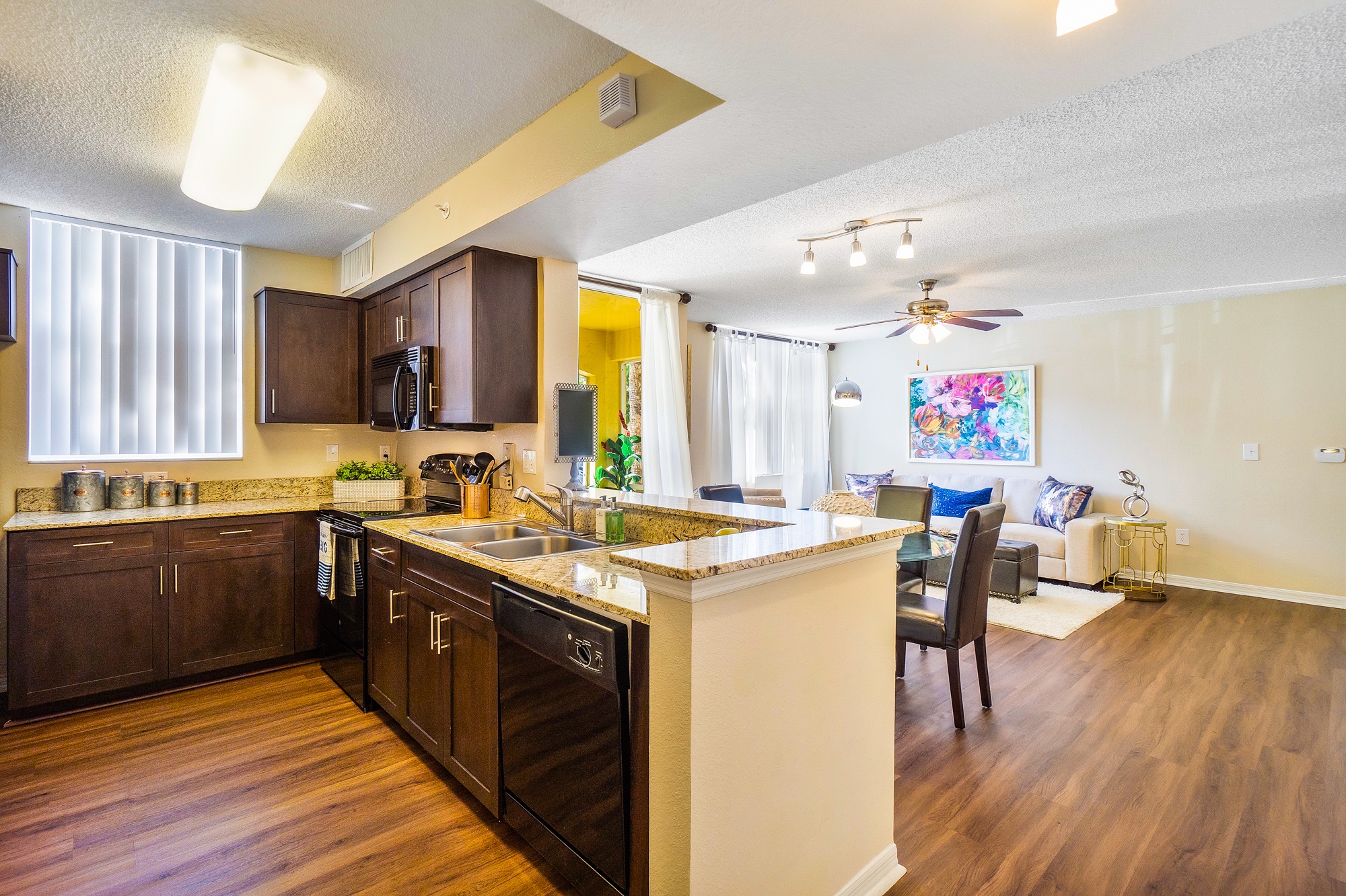 A kitchen with brown cabinets and a white island.